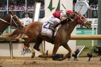 Rich Strike (21), with Sonny Leon aboard, crosses the finish line to win the 148th running of the Kentucky Derby horse race at Churchill Downs Saturday, May 7, 2022, in Louisville, Ky. (AP Photo/Mark Humphrey)