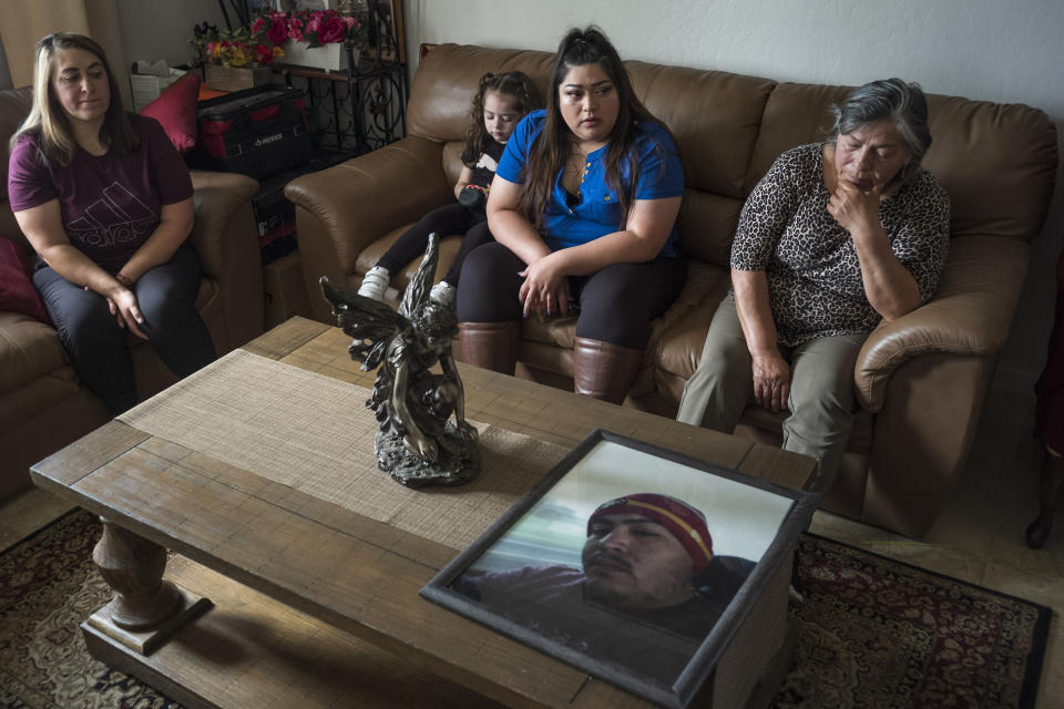 Family members of Jerry Ramos become emotional when looking at a photo of him at the family home in Watsonville, Calif., Sunday, June 6, 2021. He died Feb. 15 at age 32, becoming not just one of the roughly 600,000 Americans who have now perished in the outbreak but another example of the virus’s strikingly uneven and ever-shifting toll on the nation’s racial and ethnic groups. (AP Photo/Nic Coury)