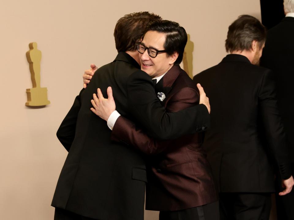Robert Downey Jr. and Ke Huy Quan hugging in the press room during the 2024 Oscars.
