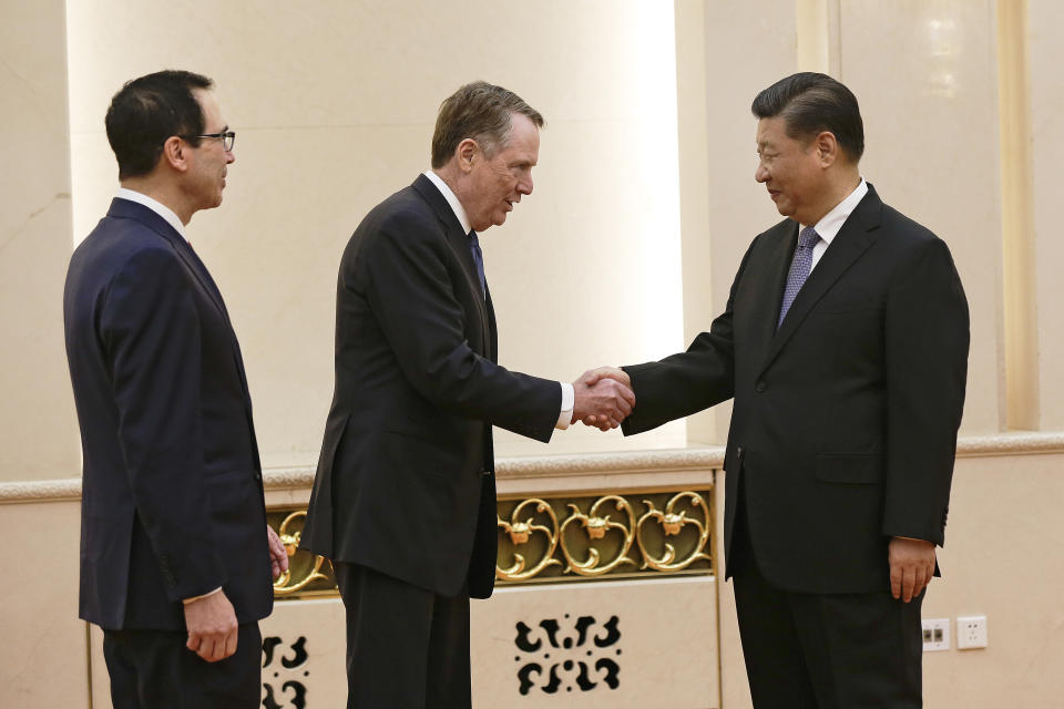 U.S. Trade Representative Robert Lighthizer, center, shakes hands with Chinese President Xi Jinping next to U.S. Treasury Secretary Steven Mnuchin, left, before their meeting at the Great Hall of the People in Beijing, Friday, Feb. 15, 2019. (AP Photo/Andy Wong, Pool)