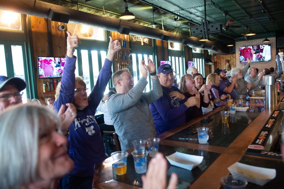 A Kansas State first down prompts a celebration Saturday for those at Kite's Bar and Grill in Manhattan. Fans gathered to watch the Wildcats take on Alabama in the Sugar Bowl.