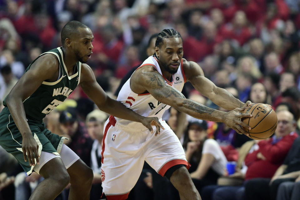 Toronto Raptors forward Kawhi Leonard (2) holds the ball away from Milwaukee Bucks forward Khris Middleton (22) during the first half of Game 4 of the NBA basketball playoffs Eastern Conference finals, Tuesday, May 21, 2019 in Toronto. (Frank Gunn/The Canadian Press via AP)