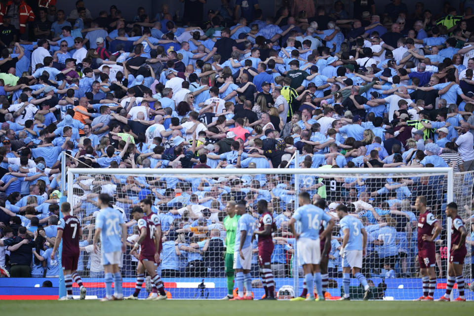 Manchester City fans celebrate after Manchester City's Rodrigo scores his side's third goal during the English Premier League soccer match between Manchester City and West Ham United at the Etihad Stadium in Manchester, England, Sunday, May 19, 2024. (AP Photo/Dave Thompson)