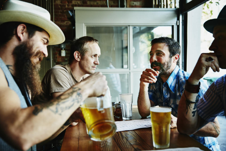Men drinking in a pub. (Getty Images)