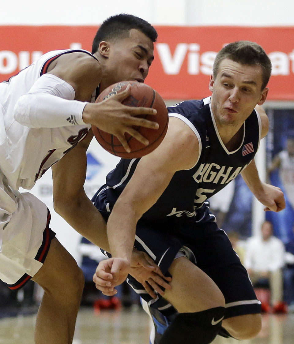 Saint Mary's Stephen Holt, left, drives against BYU's Kyle Collinsworth in the second half of an NCAA college basketball game on Saturday, Feb. 15, 2014, in Moraga, Calif. (AP Photo/Ben Margot)