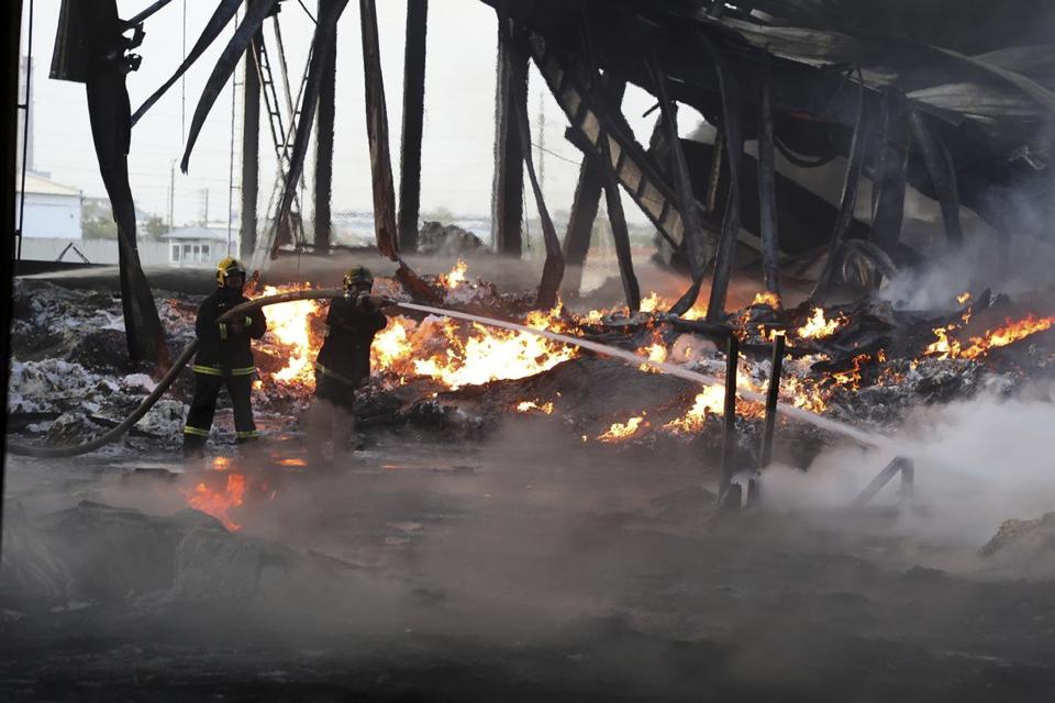 In this photo released by Uzbekistan's Emergency Ministry Press Service on Thursday, Sept. 28, 2023, firefighters work to extinguish a fire at a site of a warehouse in Tashkent, Uzbekistan. A massive explosion followed by a large blaze occurred early Thursday morning at a warehouse in the Uzbekistan capital Tashkent. (Uzbekistan's Emergency Ministry Press Service via AP)