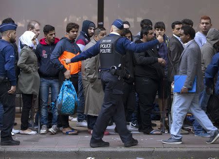 Migrants wait outside the foreign office in Brussels, Belgium, September 4, 2015. REUTERS/Yves Herman