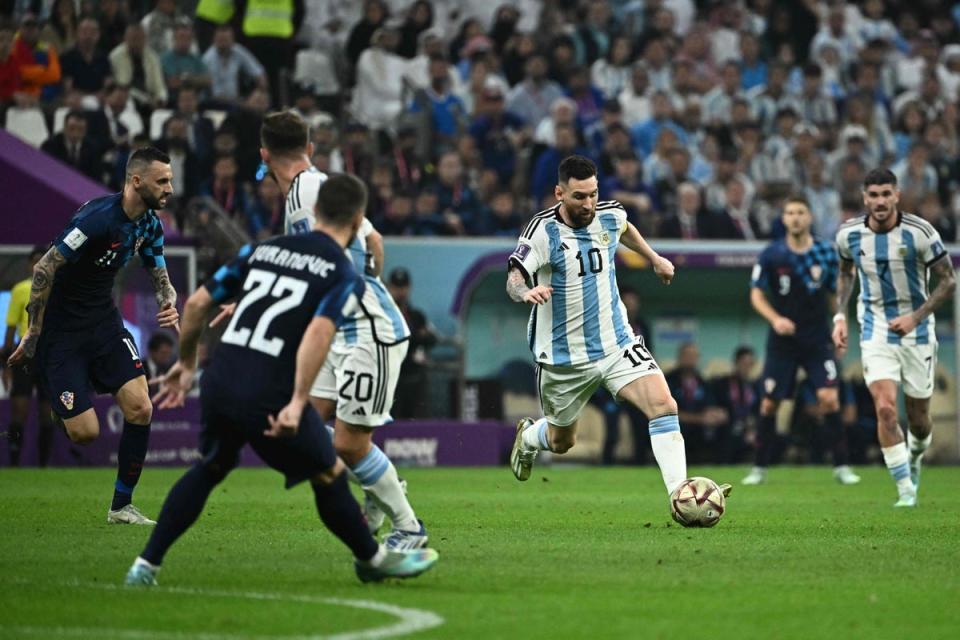 Messi dribbles during the semi-final (AFP via Getty Images)