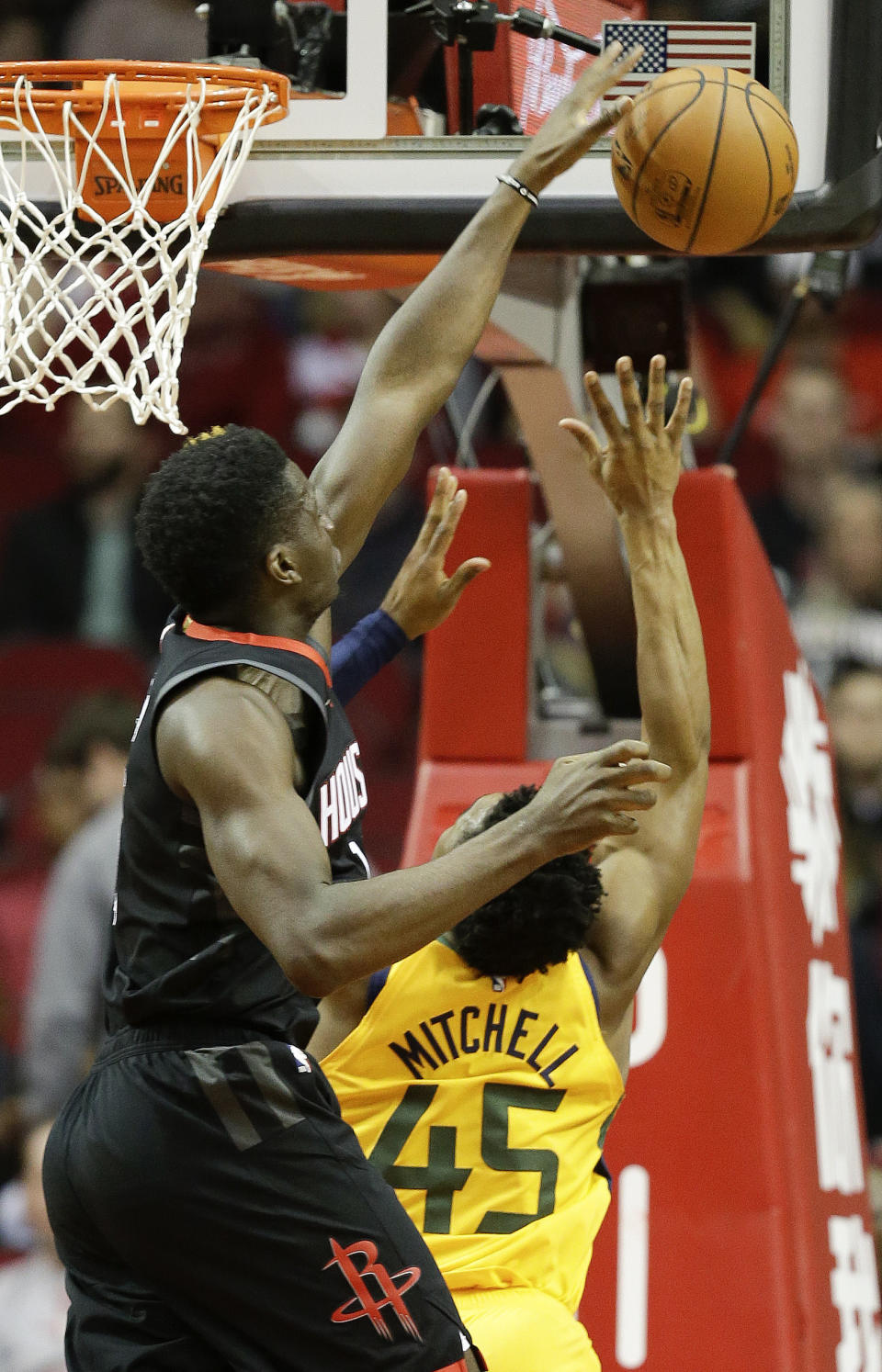 Houston Rockets center Clint Capela, left, blocks the shot of Utah Jazz guard Donovan Mitchell during the first half of an NBA basketball game, Monday, Dec. 17, 2018, in Houston. (AP Photo/Eric Christian Smith)