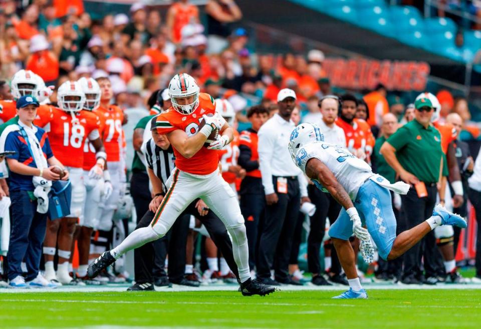 Miami Hurricanes tight end Will Mallory (85) catches a pass against North Carolina Tar Heels linebacker Cedric Gray (33) during the first quarter of an ACC conference football game at Hard Rock Stadium on Saturday, October 8, 2022 in Miami Gardens, Florida..