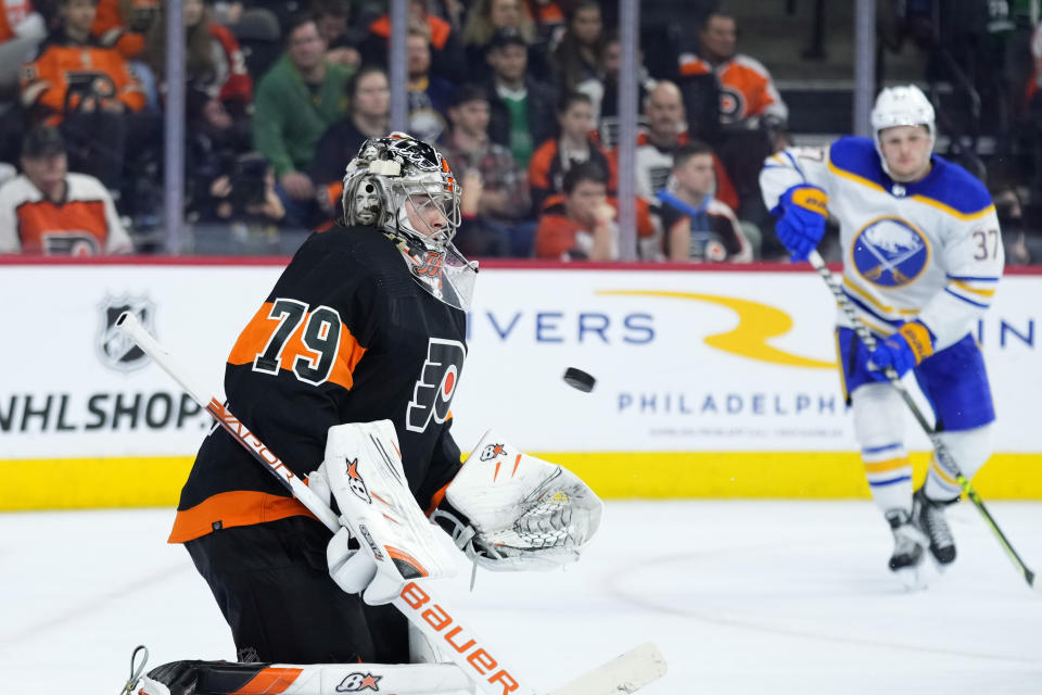 Philadelphia Flyers' Carter Hart, left, blocks a shot during the third period of an NHL hockey game against the Buffalo Sabres, Friday, March 17, 2023, in Philadelphia. (AP Photo/Matt Slocum)