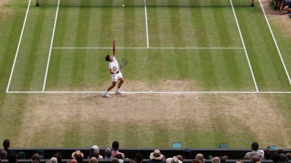 Alcaraz serves against Medvedev in the semifinal match on Friday. - Clive Brunskill/Getty Images