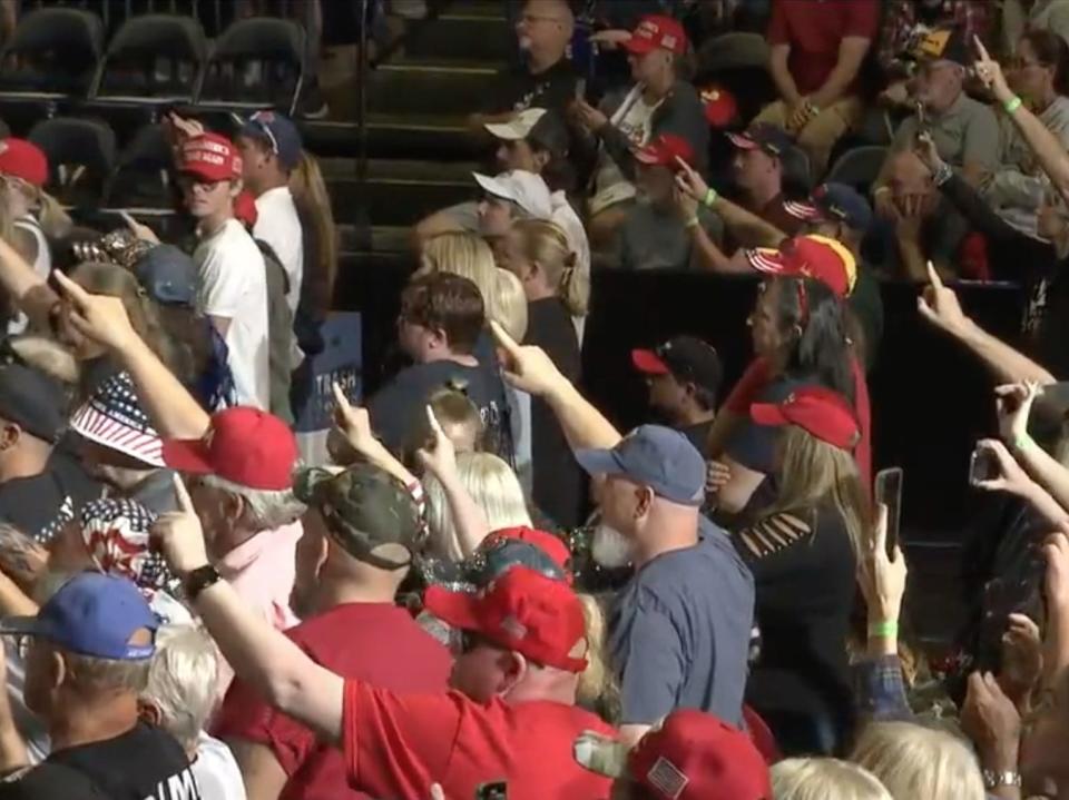 Supporters point fingers to sky at Trump rally