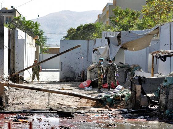 Afghan security forces work at the site of a suicide attack near the US Embassy in Kabul, Afghanistan, hours after a suicide bomb hit the president’s campaign rally. (AP)