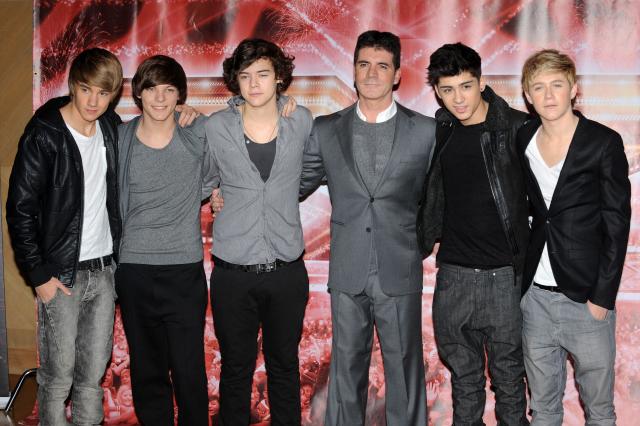 One Direction (L-R) Liam Payne, Louis Tomlinson, Harry Styles, (with Mentor Simon Cowell) Zayn Malik and Niall Horan during the X Factor Press Conference ahead of the live final on the 11th and 12th of December 2010, London