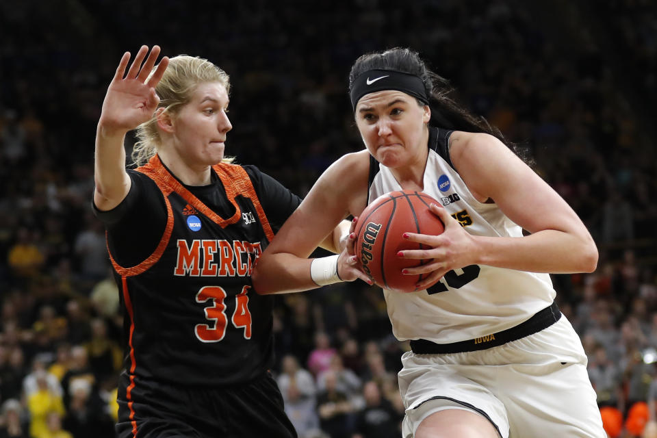 FILE - In this March 22, 2019, file photo, Iowa forward Megan Gustafson, right, drives to the basket past Mercer center Rachel Selph during a first-round game in the NCAA women's college basketball tournament in Iowa City, Iowa. Former Iowa star Gustafson was drafted by the WNBA Dallas Wings before getting cut just before final rosters were announced. The AP Player of the Year will be competing with an Iowa alumni team in The Basketball Tournament. (AP Photo/Charlie Neibergall, File)