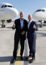 Tom Enders, President and Chief Executive Officer of Airbus and Alain Bellemare, President and Chief Executive Officer of Bombardier, pose in front of an Airbus A320neo aircraft and a Bombardier CSeries aircraft during a news conference to announce their partnership on the C Series aircraft programme, in Colomiers near Toulouse, France, October 17, 2017. REUTERS/Regis Duvignau