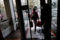 An employee of Farley’s East cafe, that closed due to the financial crisis caused by the coronavirus disease (COVID-19), carries donated food items after being laid off from the cafe in Oakland