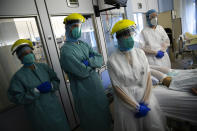 FILE - In this Wednesday, Oct. 21, 2020 file photo, medical staff workers look at vital sign monitors as they tend to a patient in the intensive care ward for COVID-19 patients at the CHR Citadelle hospital in Liege, Belgium. The European Union executive announced Thursday, March 4, 2021 that it wants to force employers to be much more open about how much money staff makes to make it easier for women to challenge wage imbalances and further closer the gender pay gap. The EU made it clear that women workers had been disproportionally affected by the pandemic, many having to add more home tasks to their work schedule because of closure of schools and day care centers. (AP Photo/Francisco Seco, File)