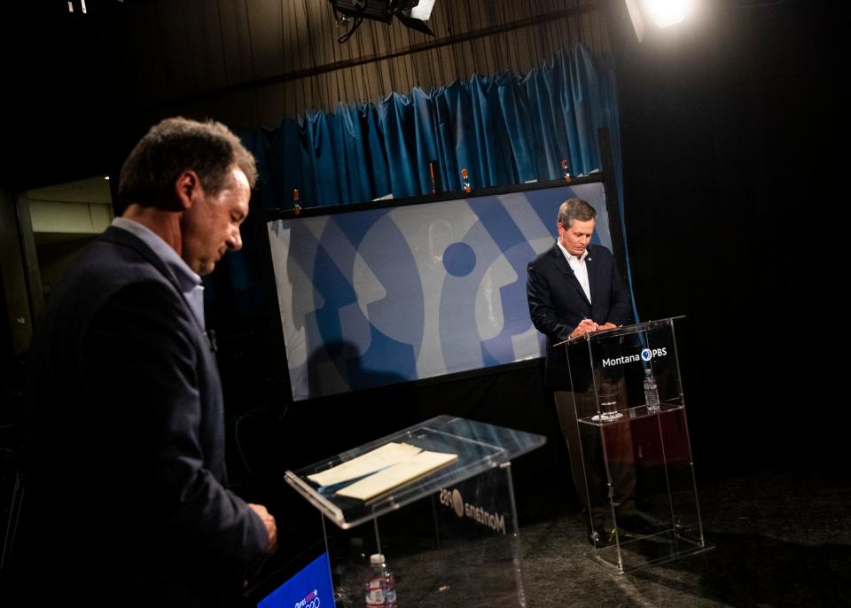 Gov. Steve Bullock, left, and U.S. Sen. Steve Daines, R-Mont., prepare their notes before the beginning of their televised debate at the KUFM-TV studio at the University of Montana on Monday, Sept. 28, 2020, in Missoula, Mont. (Ben Allan Smith/The Missoulian via AP)