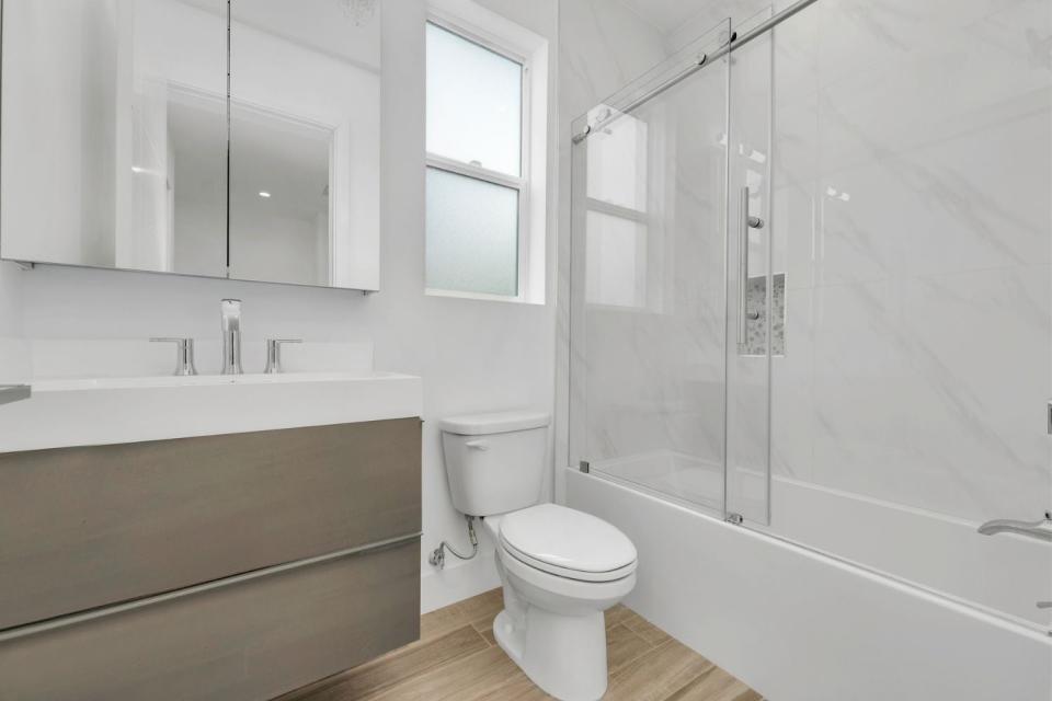 A view of a pristine white bathroom. 