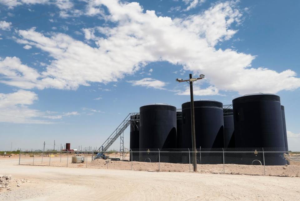Produced water is stored in tanks outside Pecos, Texas in August 2023. Disposing of billions of gallons of produced water is a growing challenge for the oil and gas industry in Texas.
