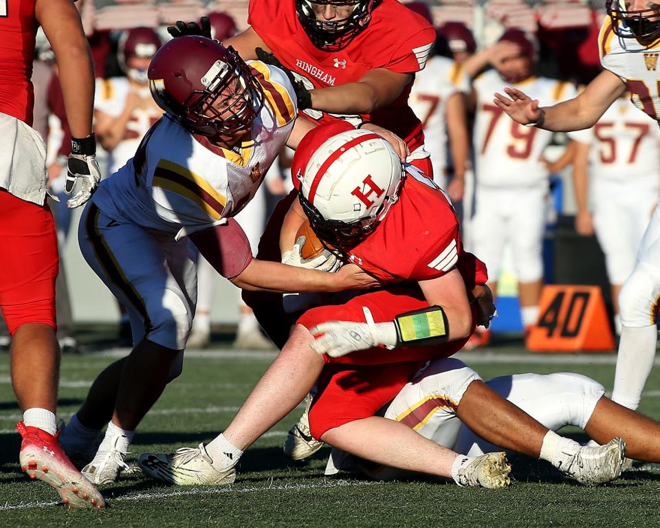 Weymouth's Shawn Hogan and Weymouth's Dillon Adams take down Hingham's Jeremy Aylward during at Hingham High on Saturday, Sept. 24, 2022.