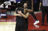 San Diego State's Jordan Schakel (20) and Matt Mitchell (11) celebrate after defeating UNLV during an NCAA college basketball game Wednesday, March 3, 2021, in Las Vegas. (AP Photo/Joe Buglewicz)