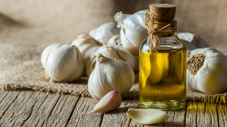 garlic bulbs and oil on table