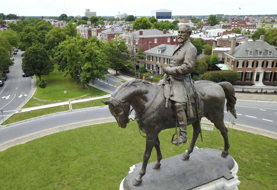 FILE - This Tuesday, June 27, 2017 file photo shows the statue of Confederate General Robert E. Lee that stands in the middle of a traffic circle on Monument Avenue in Richmond, Va. Virginia Gov. Ralph Northam is expected to announce plans Thursday for the removal of an iconic statue of Confederate Gen. Robert E. Lee from Richmond's prominent Monument Avenue. (AP Photo/Steve Helber, File)