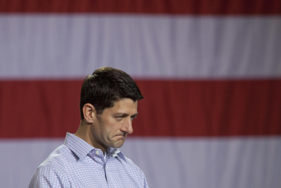 Republican vice presidential candidate, U.S. Rep. Paul Ryan (R-WI) listens as his running mate, Republican presidential candidate and former Massachusetts Governor Mitt Romney speaks during the Mooresville Victory Rally August 12, 2012 at NASCAR Technical Institute in Mooresville, North Carolina. Mitt Romney will make stops in Florida and Ohio during his four-day bus tour. (Photo by John Adkisson/Getty Images)