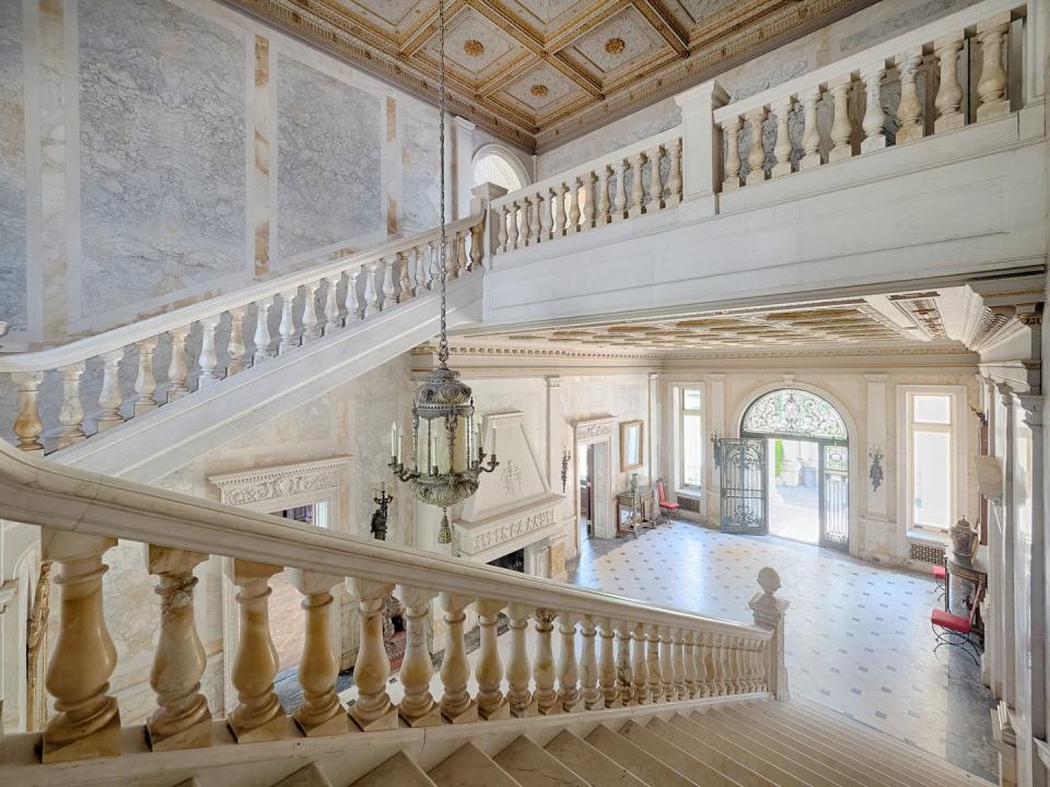 The foyer's white marble staircase reportedly cost $2 million to build.