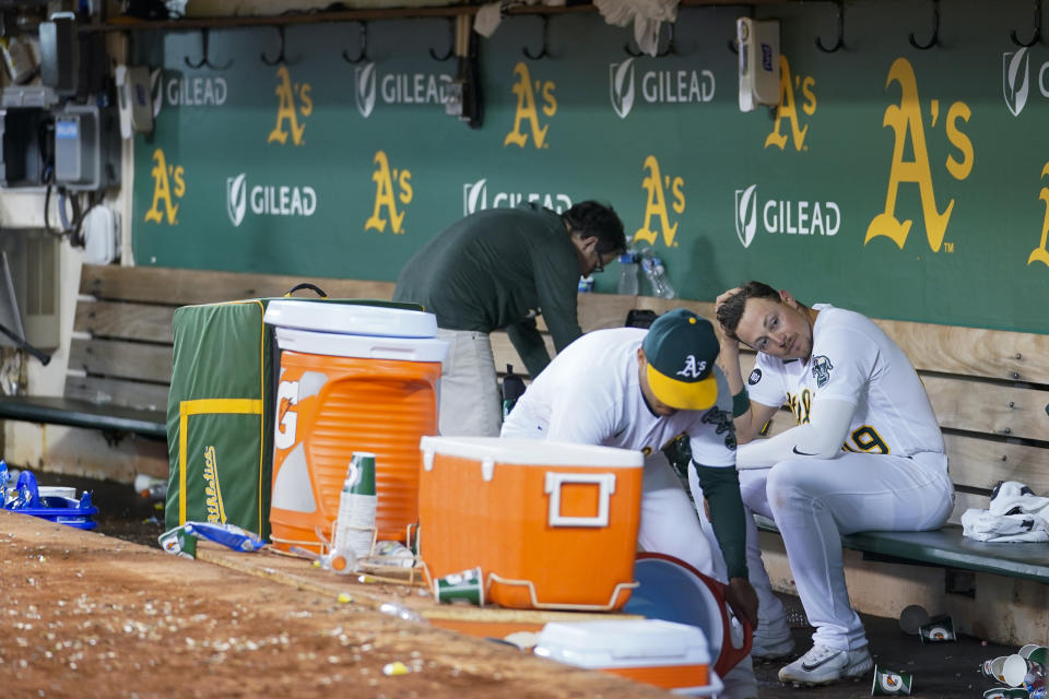 Oakland Athletics' Ryan Noda, right, sits in the dugout after the team's 6-1 loss to the Philadelphia Phillies in a baseball game in Oakland, Calif., Friday, June 16, 2023. (AP Photo/Godofredo A. Vásquez)