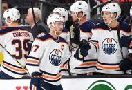 Apr 1, 2019; Las Vegas, NV, USA; Edmonton Oilers center Connor McDavid (97) celebrates with teammates on the bench after scoring a goal during the second period against the Vegas Golden Knights at T-Mobile Arena. Mandatory Credit: Stephen R. Sylvanie-USA TODAY Sports