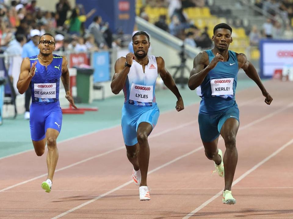 Canada's Andre De Grasse, left, placed fourth behind Americans Noah Lyles, centre, and Fred Kerley, right, during the men's 200 metres at the season-opening Diamond League event on Friday in Doha, Qatar. (Karim Jaafar/AFP via Getty Images - image credit)