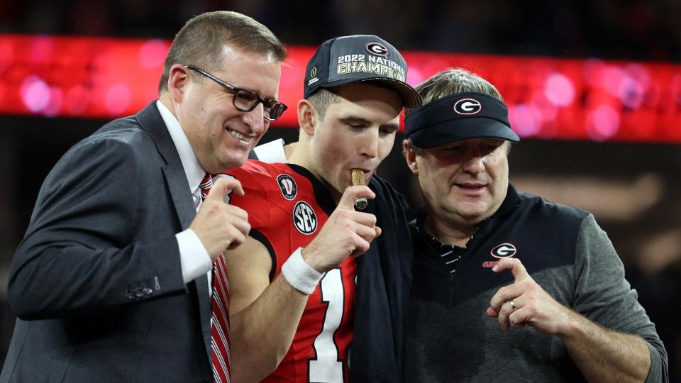 <div>Director of Athletics Josh Brooks, head coach Kirby Smart and <a class="link " href="https://sports.yahoo.com/nfl/players/40153/" data-i13n="sec:content-canvas;subsec:anchor_text;elm:context_link" data-ylk="slk:Stetson Bennett;sec:content-canvas;subsec:anchor_text;elm:context_link;itc:0">Stetson Bennett</a> #13 of the Georgia Bulldogs celebrate after defeating the TCU Horned Frogs in the College Football Playoff National Championship game at SoFi Stadium on January 09, 2023 in Inglewood, California. Georgia defeated TCU 65-7. (Photo by Ezra Shaw/Getty Images)</div>