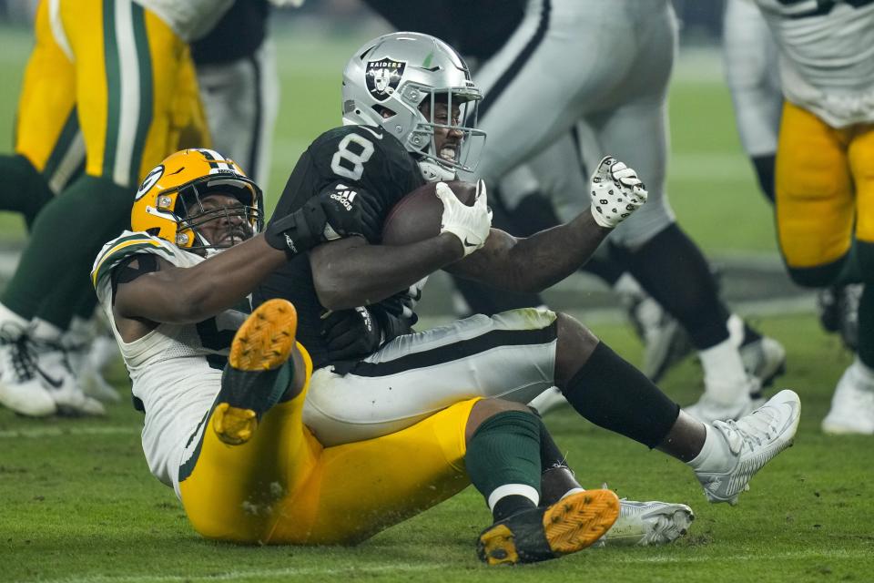 Green Bay Packers' Kingsley Enagbare stops Las Vegas Raiders' Josh Jacobs for a loss during the second half of an NFL football game Monday, Oct. 9, 2023, in Las Vegas. (AP Photo/John Locher)
