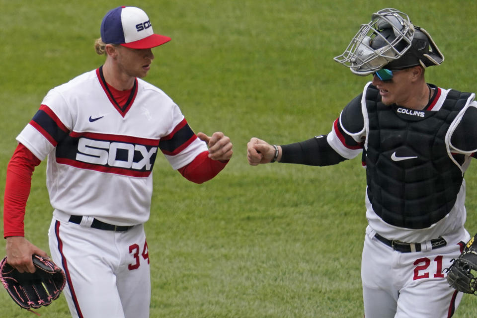 Chicago White Sox starting pitcher Michael Kopech, left, celebrates with catcher Zack Collins as they walk to the dugout after the fifth inning of a baseball game against the Texas Rangers in Chicago, Sunday, April 25, 2021. (AP Photo/Nam Y. Huh)