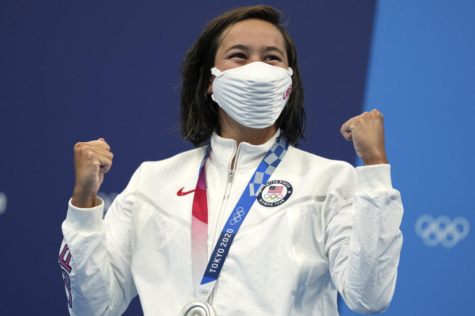 Erica Sullivan of the United States raises her hands on the podium after receiving her silver medal for the women's 1500-meters freestyle at the 2020 Summer Olympics, Wednesday, July 28, 2021, in Tokyo, Japan. (AP Photo/Matthias Schrader)