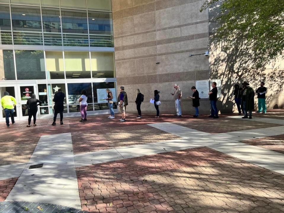 A long line of people stood in front of the Mecklenburg County Sheriff’s Office on Thursday morning, May 12, 2022, as they waited to get their fingerprints taken for their gun permits.