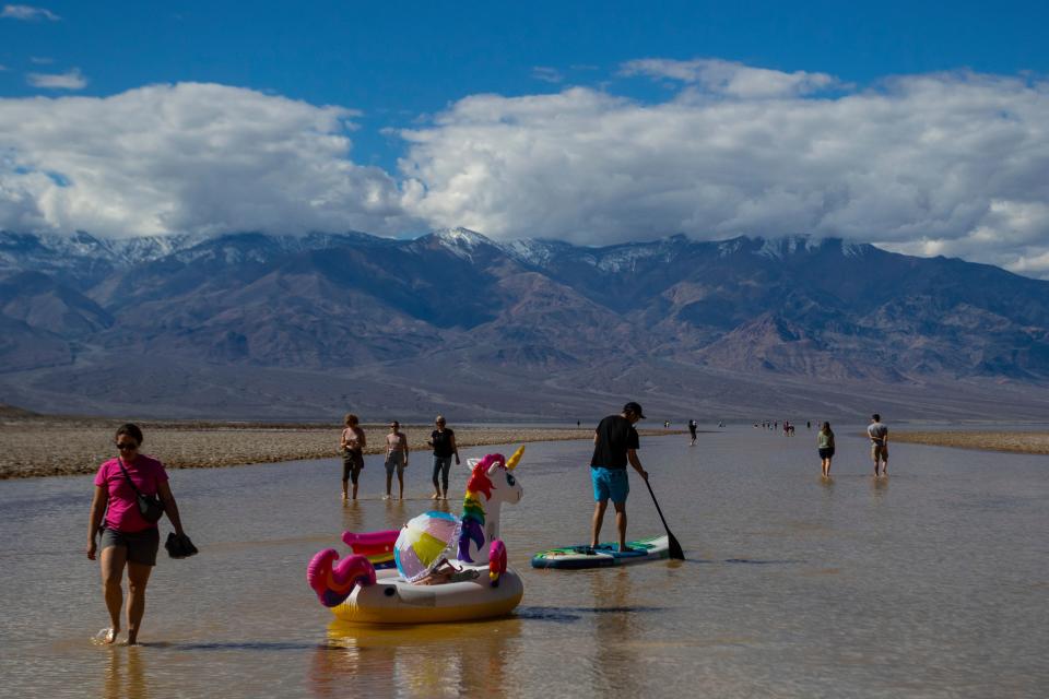People at Death Valley's temporary lake in February 2024.