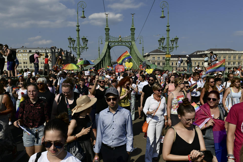 People march across the Szabadsag, or Freedom Bridge over the River Danube in downtown Budapest during a gay pride parade in Budapest, Hungary, Saturday, July 24, 2021. Rising anger over policies of Hungary's right-wing government filled the streets of the country's capital on Saturday as thousands of LGBT activists and supporters marched in the city's Pride parade. (AP Photo/Anna Szilagyi)