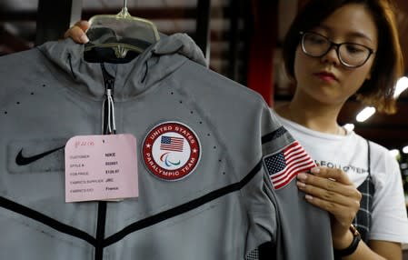 An employee shows a Nike's jacket for USA Paralympic 2012 team which was produced by Maxport garment company at its company in Hanoi