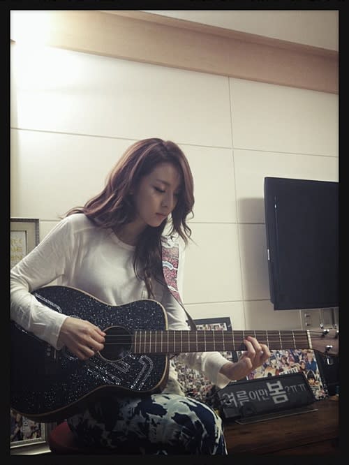 Sandara Park practicing her guitar