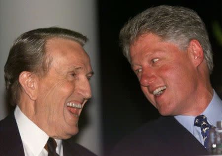 U.S. President Bill Clinton and former Sen. Dale Bumpers (L) laugh as they watch a video about the life of Bumpers in Little Rock, Arkansas, in this file photo taken March 13, 1999. REUTERS/Staff/Files