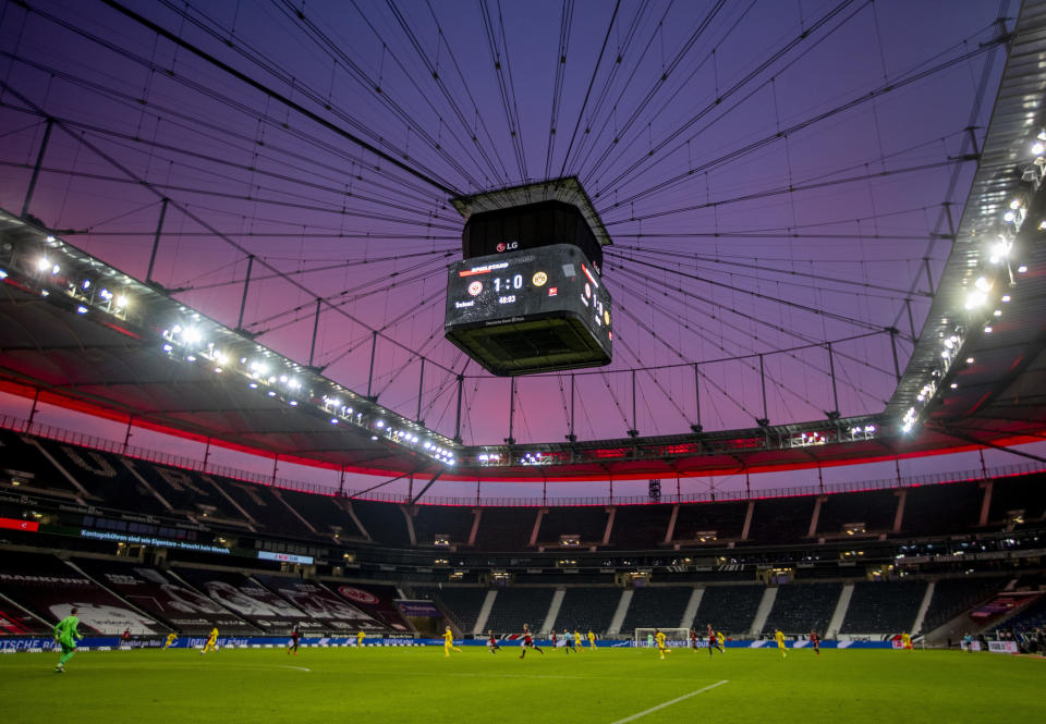 File - The empty stadium is seen after sunset during a German Bundesliga soccer match between Eintracht Frankfurt and Borussia Dortmund in Frankfurt, Germany, Saturday, Dec. 5, 2020. The European Championship in Germany is all about tried and tested stadiums with a rich soccer history. Unlike at some recent World Cups, there's been no rush to finish stadiums on time. (AP Photo/Michael Probst,Pool, File)