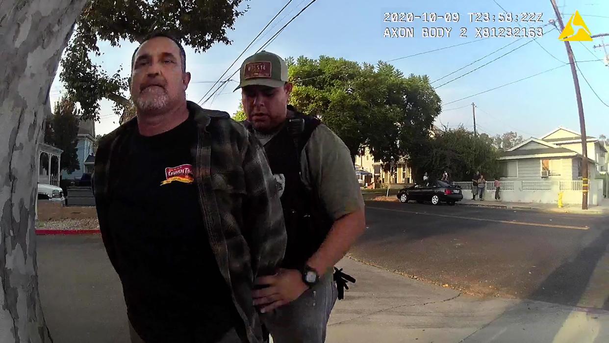 Retired Oxnard firefighter Joe Garces, left, is detained by Santa Paula police officer Chris Rivera on Oct. 9, 2020, after Garces performed CPR on a gunshot victim in Santa Paula. Garces eventually filed a federal lawsuit against the city and Rivera for civil rights violations, and the case has been settled out of court.