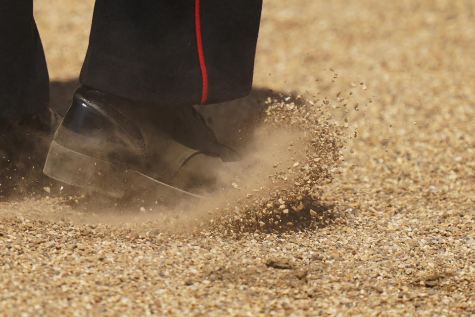 A view of gravel as a soldier marches during the Colonel's Review, the final rehearsal of the Trooping the Colour, the King's annual birthday parade, at Horse Guards Parade in London, Saturday, June 10, 2023. (AP Photo/Alberto Pezzali)
