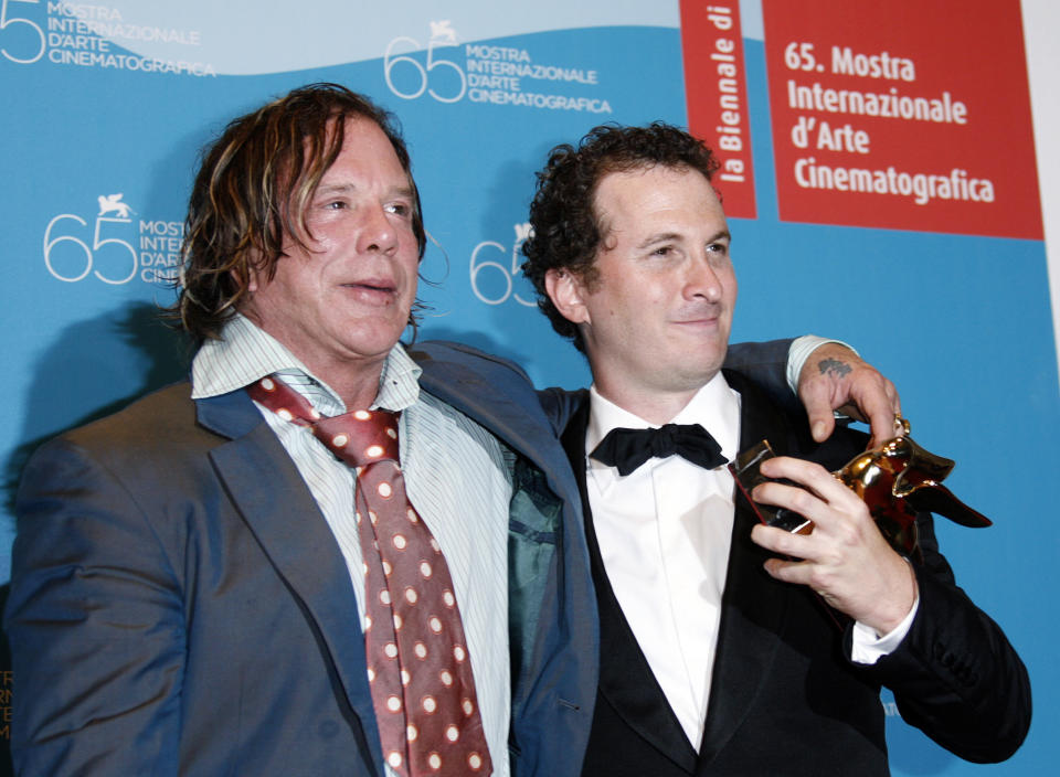 U.S. director Darren Aronofsky (R) holds the Golden Lion prize for best movie "The Wrestler" next to Mickey Rourke during a photocall at the 65th edition of the Venice Film Festival September 6, 2008. Rourke stars in the Aronofsky movie. REUTERS/Denis Balibouse (ITALY)