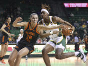 Oklahoma State guard Lexy Keys, left, reaches in on Baylor forward NaLyssa Smith while driving to the basket in the second half of an NCAA college basketball game, Wednesday, Jan. 19, 2022, in Waco, Texas. (Rod Aydelotte/Waco Tribune-Herald via AP)